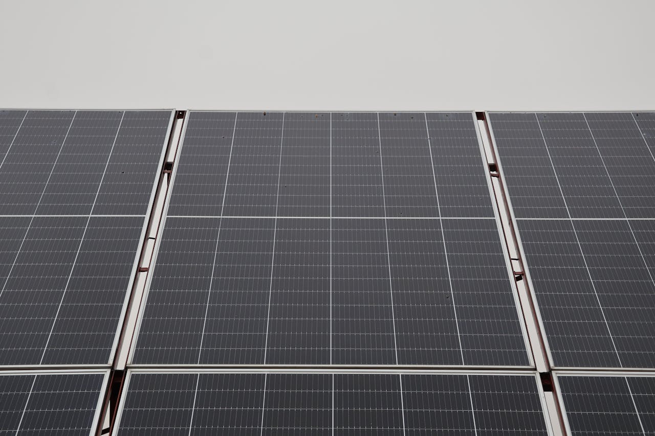 Close-up view of modern solar panels capturing renewable energy under overcast sky.